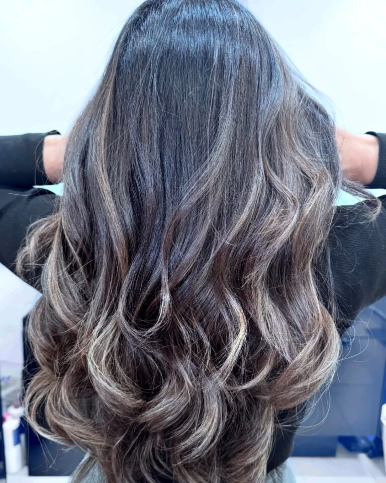 Dark brunette with cool ash balayage and bouncy curls