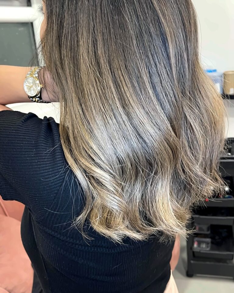 Sleek ash blonde balayage on mid-length hair